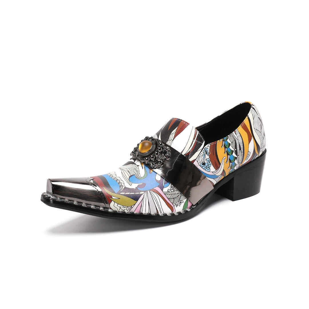 A single men's artistic patterned pointed toe shoe with a metal tip and an ornate buckle, displayed on a white background.