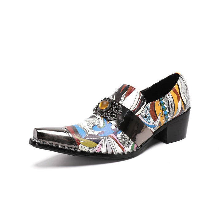A single men's artistic patterned pointed toe shoe with a metal tip and an ornate buckle, displayed on a white background.