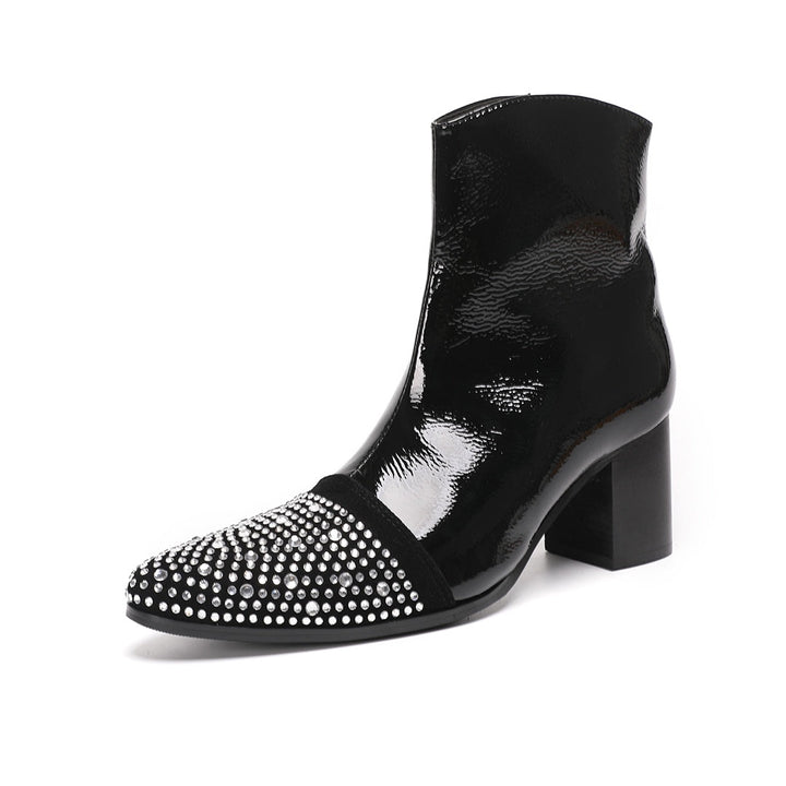 A pair of black patent leather ankle boots with rhinestone-embellished pointed toes and block heels.