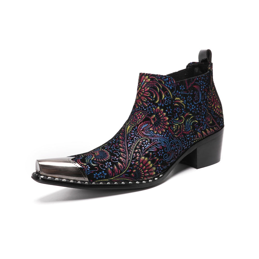 A pair of men's black ankle boots with a vibrant multicolor brocade pattern and a polished silver metal toe cap.
