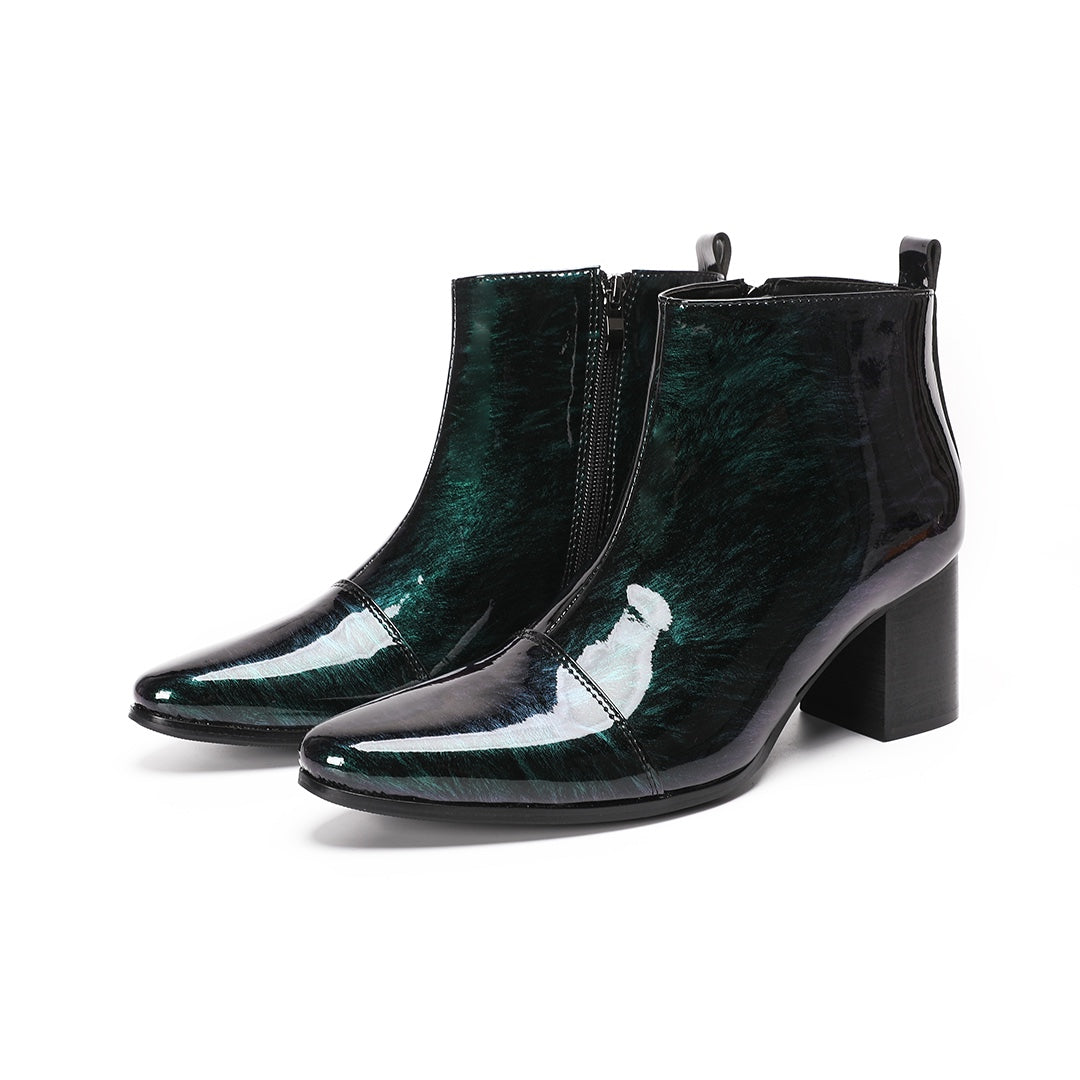Pair of iridescent dark green patent leather pointed toe ankle boots with block heels and side zippers.