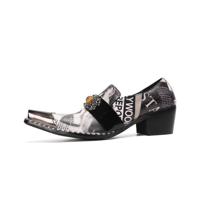 Pair of men's black and white newspaper print slip-on dress shoes with pointed silver metal toe caps and decorative buckles.
