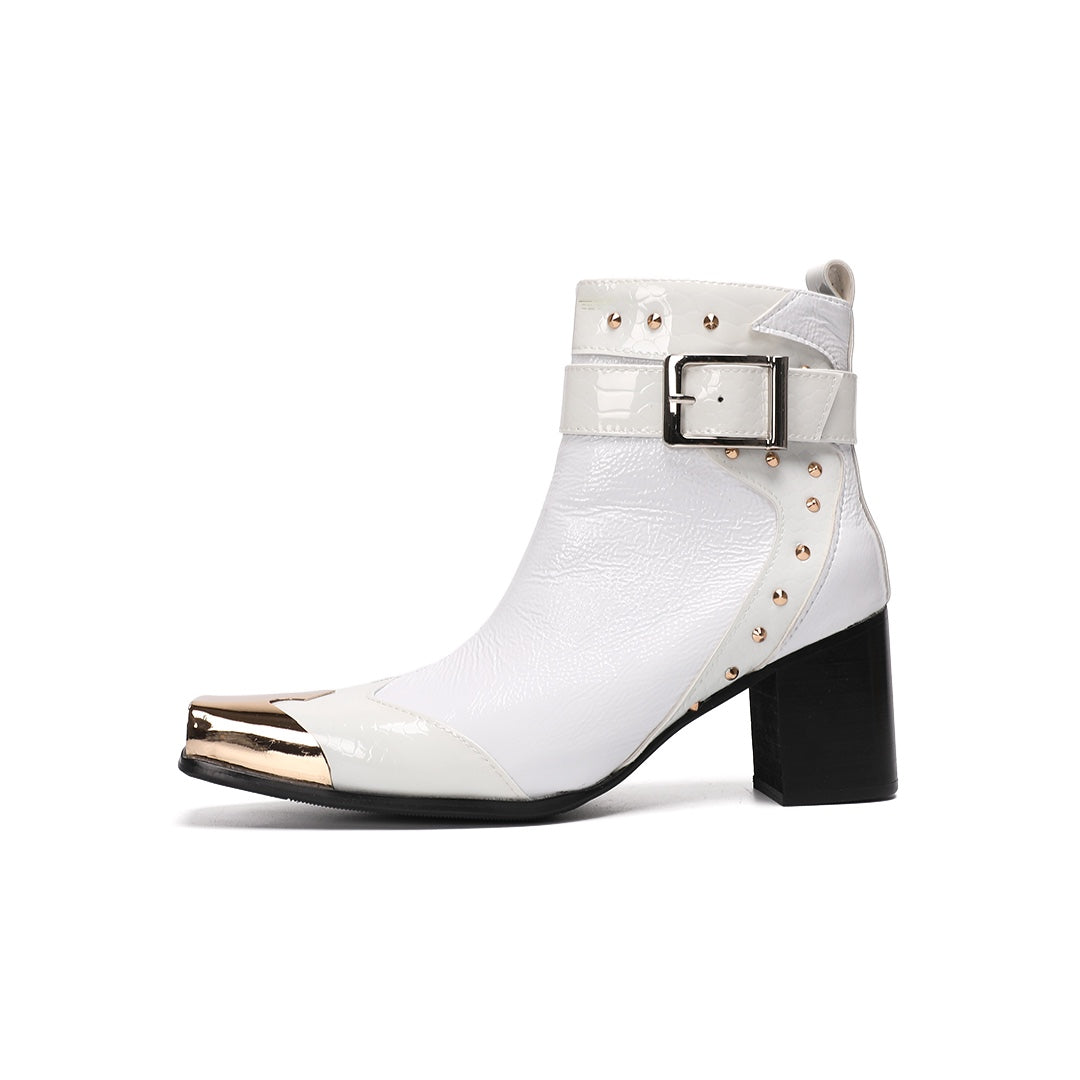 Pair of Dolashoes white patent leather ankle boots with gold metal square toe, studded buckle strap, and black block heel.