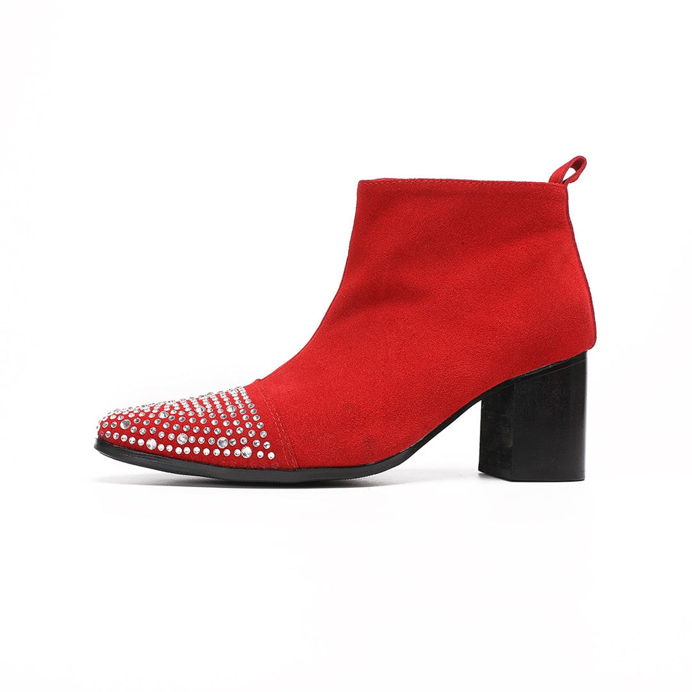 A pair of vibrant red suede ankle boots with silver rhinestones on the pointed toe and a black block heel.