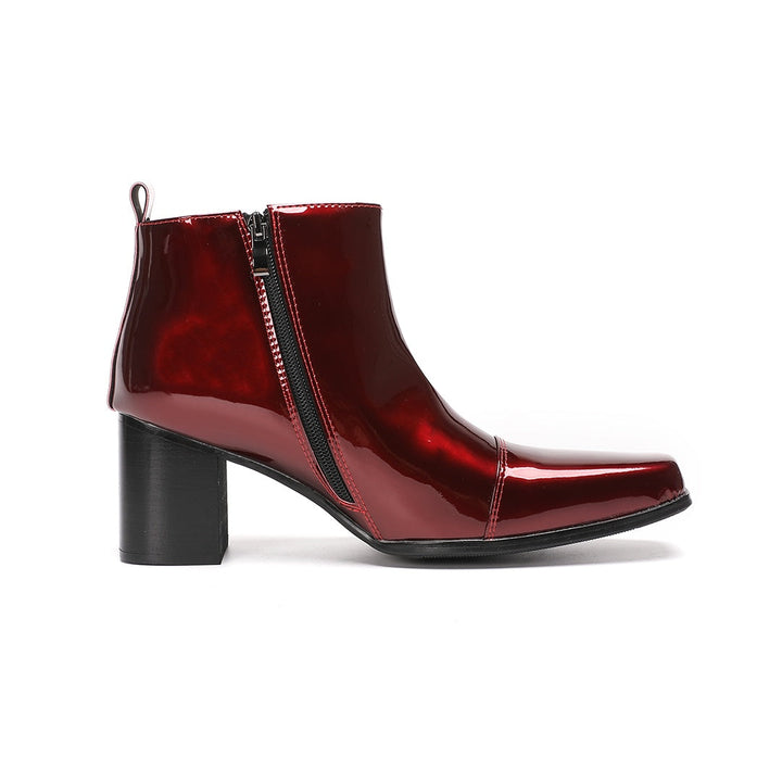 A pair of shiny burgundy patent leather ankle boots with a square toe and block heel, featuring a side zipper closure.