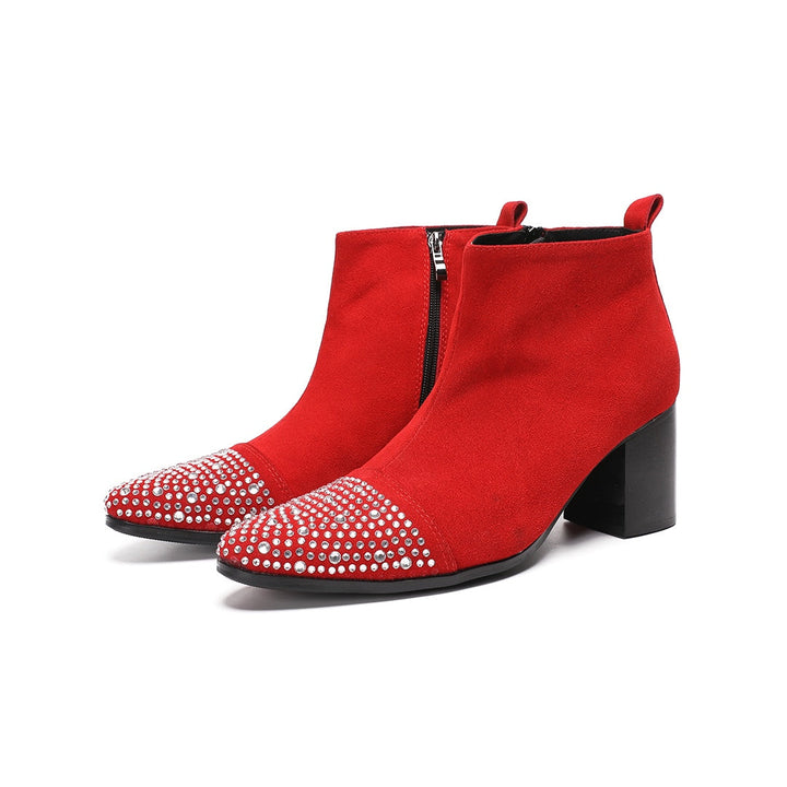 A pair of vibrant red suede ankle boots with silver rhinestones on the pointed toe and a black block heel.