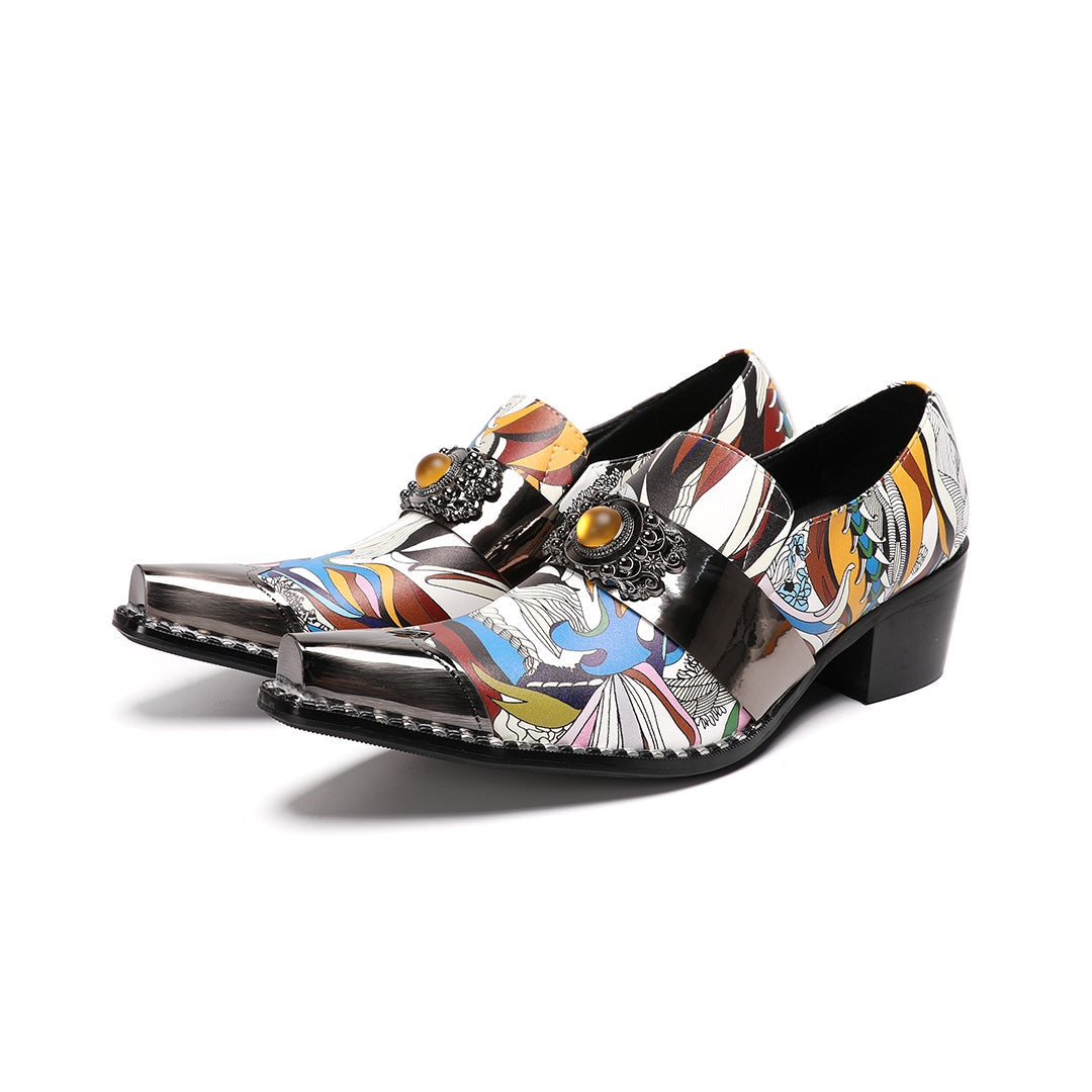 A single men's artistic patterned pointed toe shoe with a metal tip and an ornate buckle, displayed on a white background.