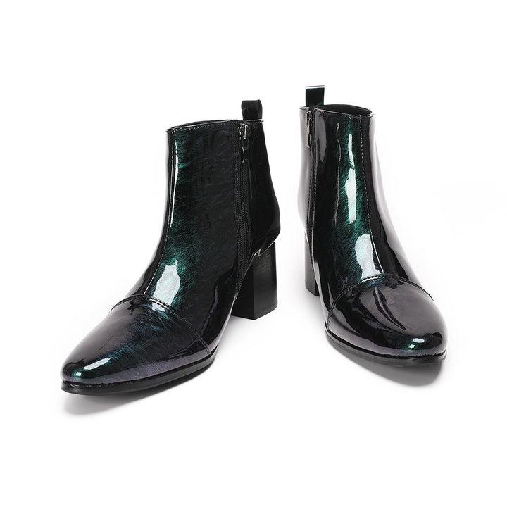 Pair of iridescent dark green patent leather pointed toe ankle boots with block heels and side zippers.