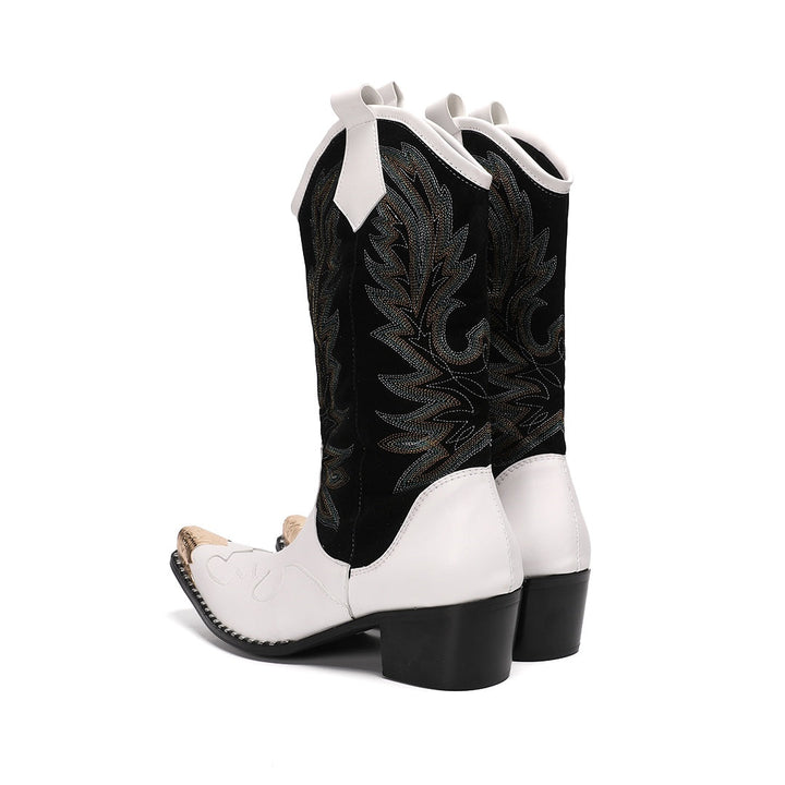 Pair of white and black embroidered cowboy boots with a gold metal tip on a white background.