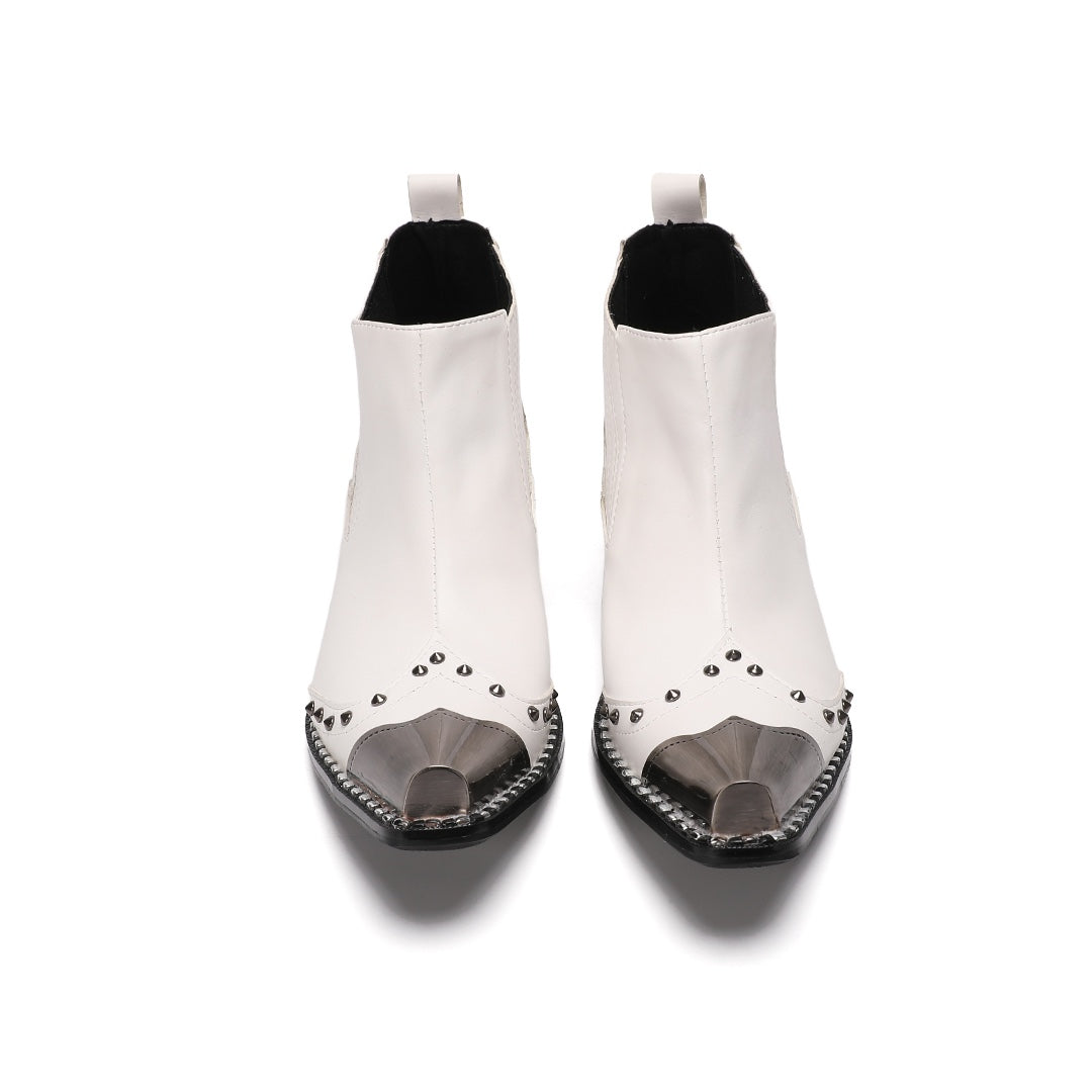 Pair of white studded Chelsea boots with silver metal toe caps and black heels on a white background.