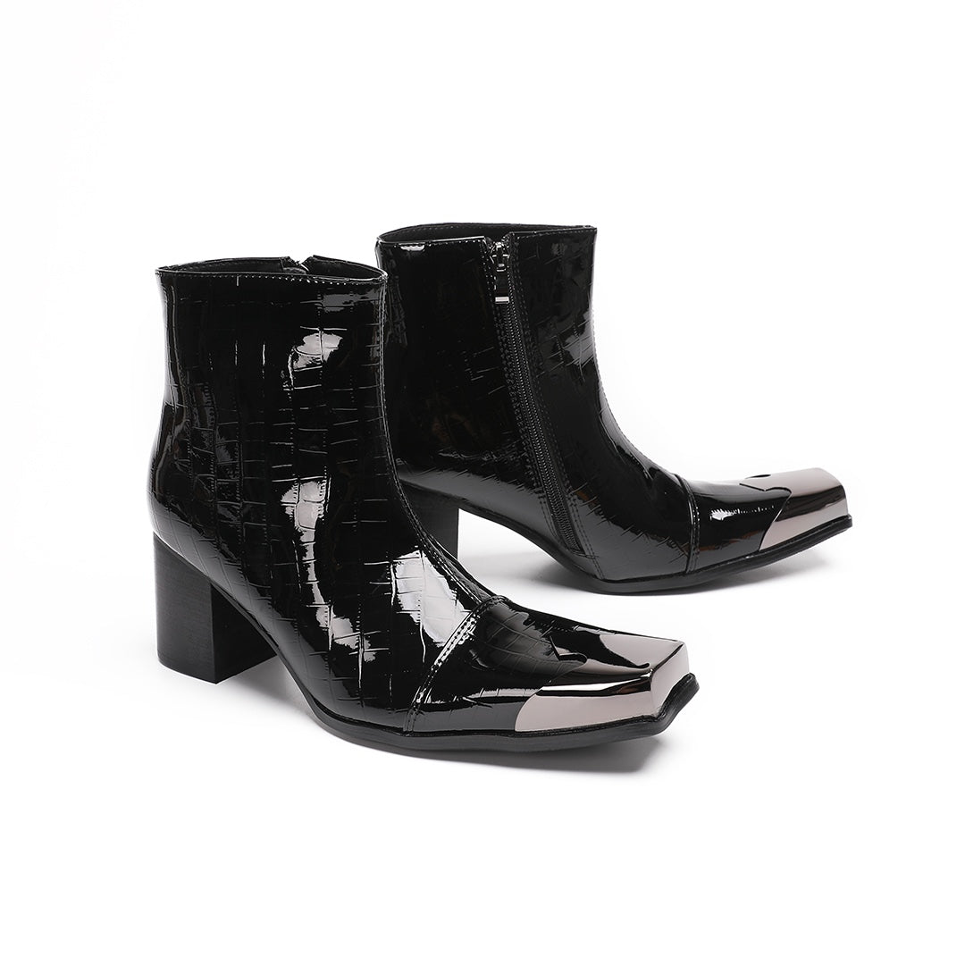 Pair of black patent crocodile embossed ankle boots with square metal toe caps and block heels, side view.