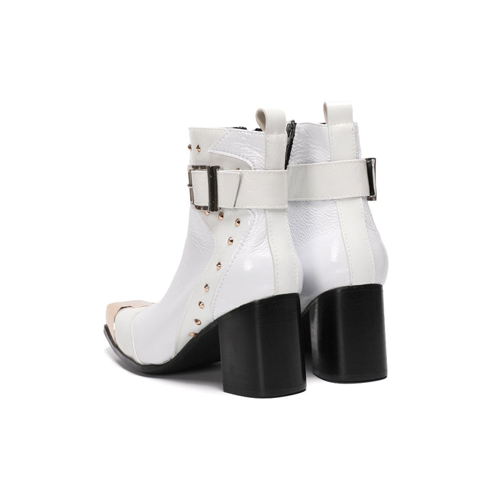 Pair of Dolashoes white patent leather ankle boots with gold metal square toe, studded buckle strap, and black block heel.