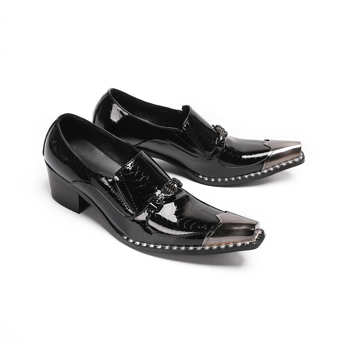 Pair of black patent leather men's loafers with silver metal cap toes and decorative buckles.
