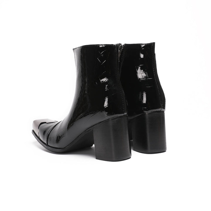 Pair of black patent crocodile embossed ankle boots with square metal toe caps and block heels, side view.