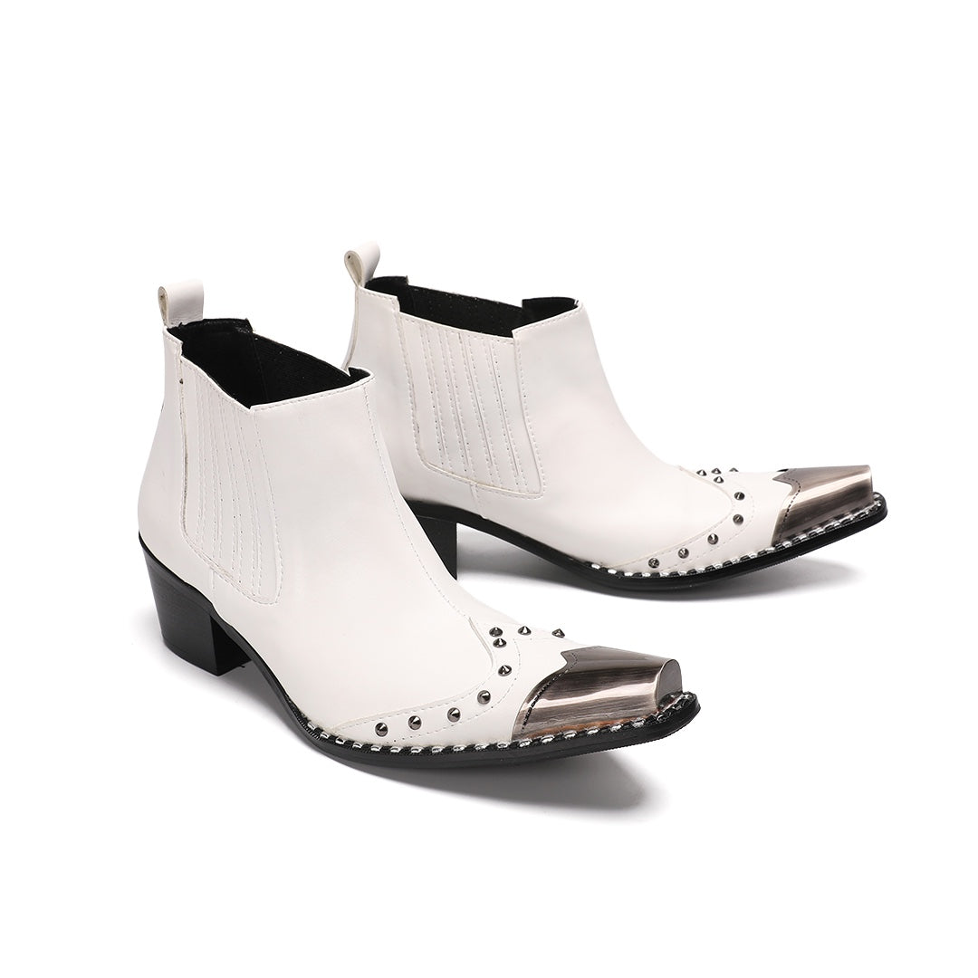 Pair of white studded Chelsea boots with silver metal toe caps and black heels on a white background.