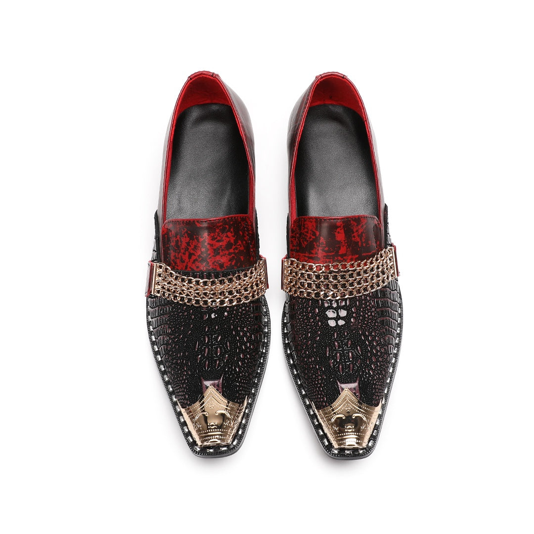 A pair of Dolashoes men's red and black textured leather loafers with gold metal toe caps and chain embellishments on a white