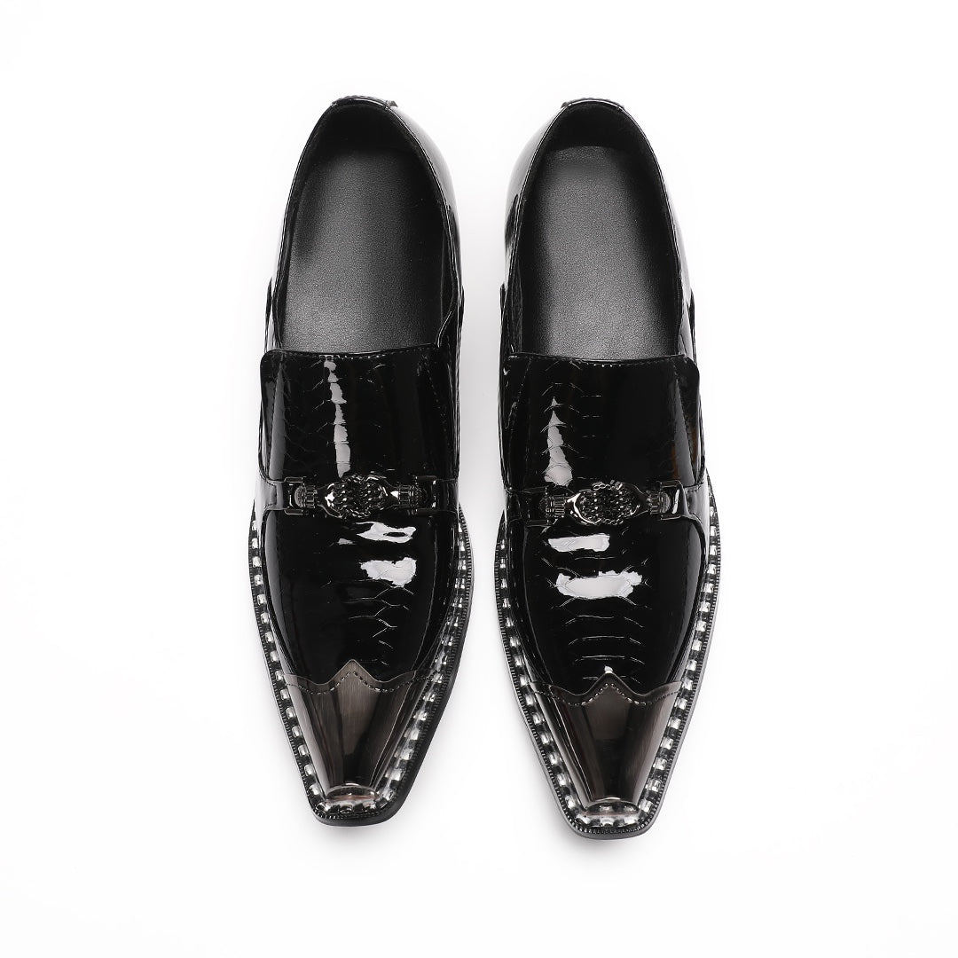 Pair of black patent leather men's loafers with silver metal cap toes and decorative buckles.
