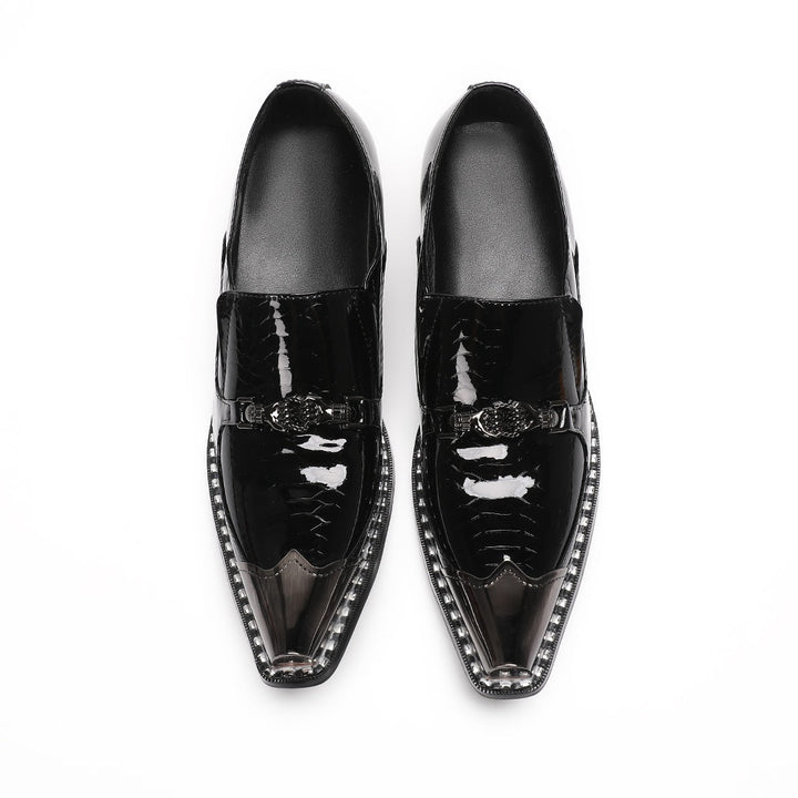 Pair of black patent leather men's loafers with silver metal cap toes and decorative buckles.