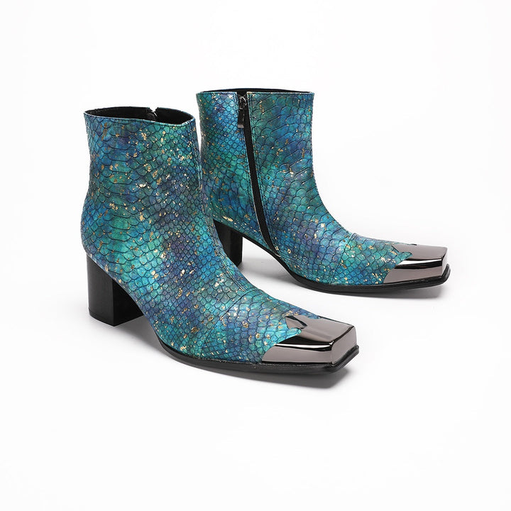 A pair of men's teal snake print ankle boots with a square metal tip and black block heel, shown on a white background.