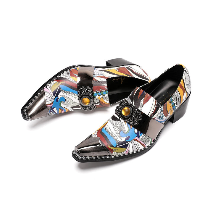 A single men's artistic patterned pointed toe shoe with a metal tip and an ornate buckle, displayed on a white background.