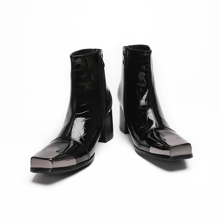 Pair of black patent crocodile embossed ankle boots with square metal toe caps and block heels, side view.