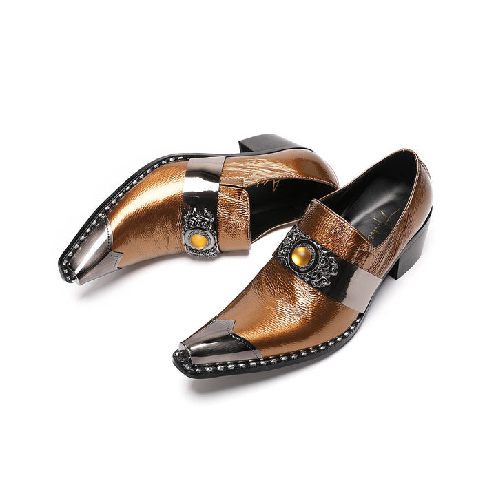 Pair of men's bronze patent leather high heel slip-on shoes with pointed metal toe caps and ornate vamp embellishments on a