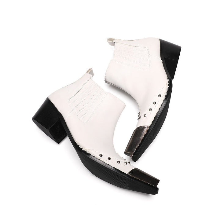 Pair of white studded Chelsea boots with silver metal toe caps and black heels on a white background.