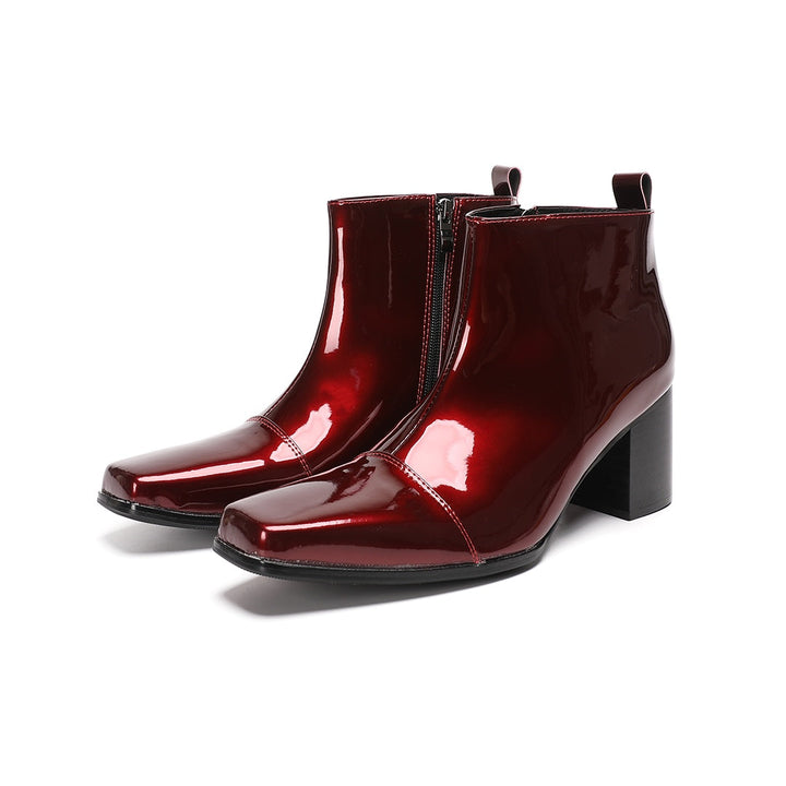 A pair of shiny burgundy patent leather ankle boots with a square toe and block heel, featuring a side zipper closure.