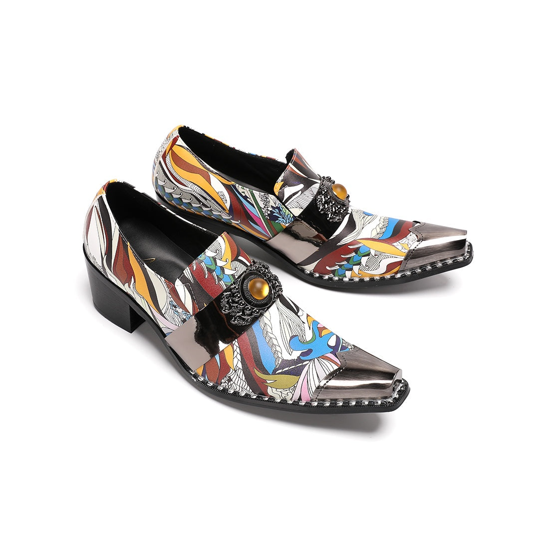 A single men's artistic patterned pointed toe shoe with a metal tip and an ornate buckle, displayed on a white background.
