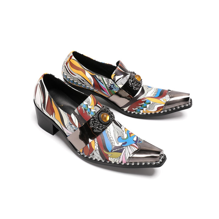 A single men's artistic patterned pointed toe shoe with a metal tip and an ornate buckle, displayed on a white background.