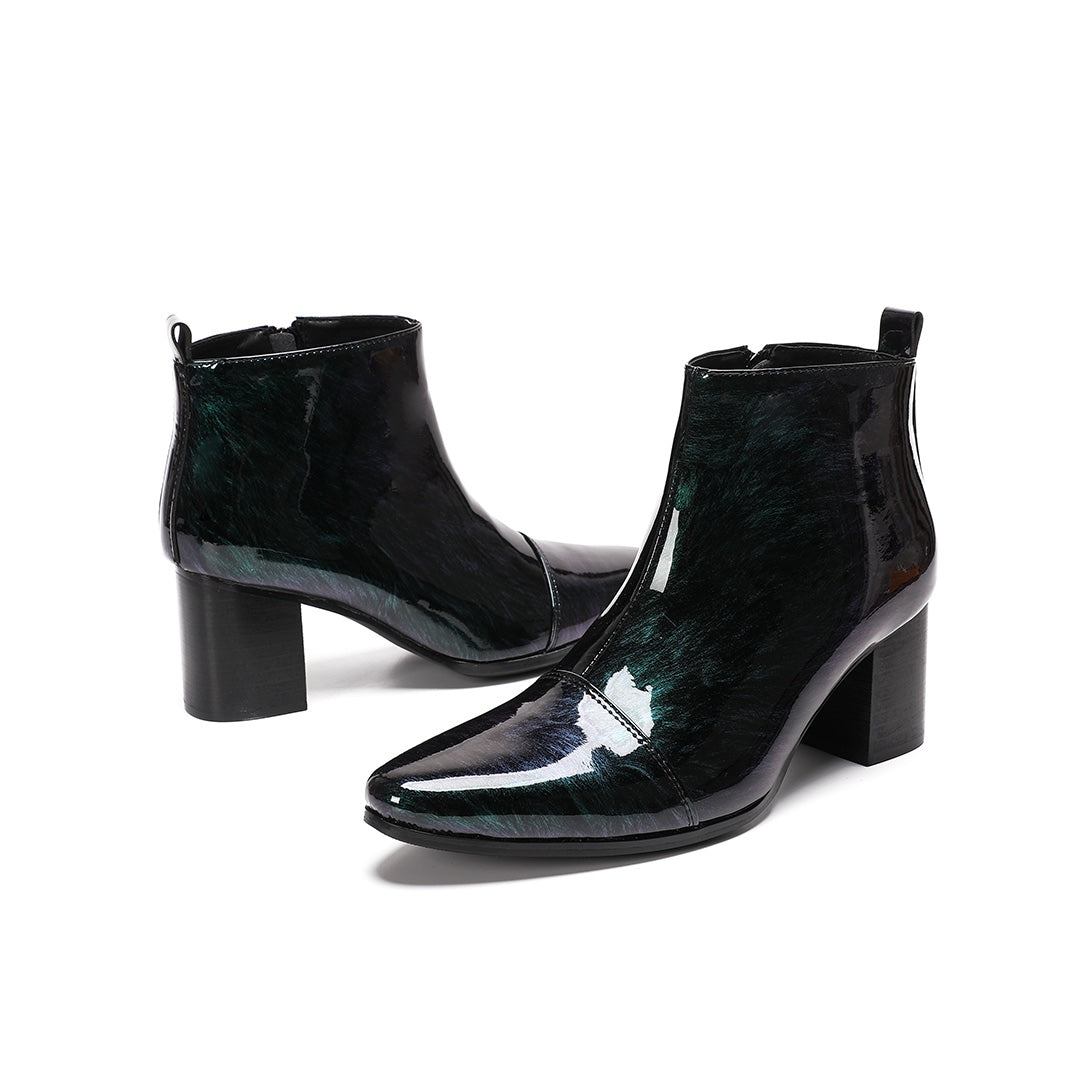 Pair of iridescent dark green patent leather pointed toe ankle boots with block heels and side zippers.