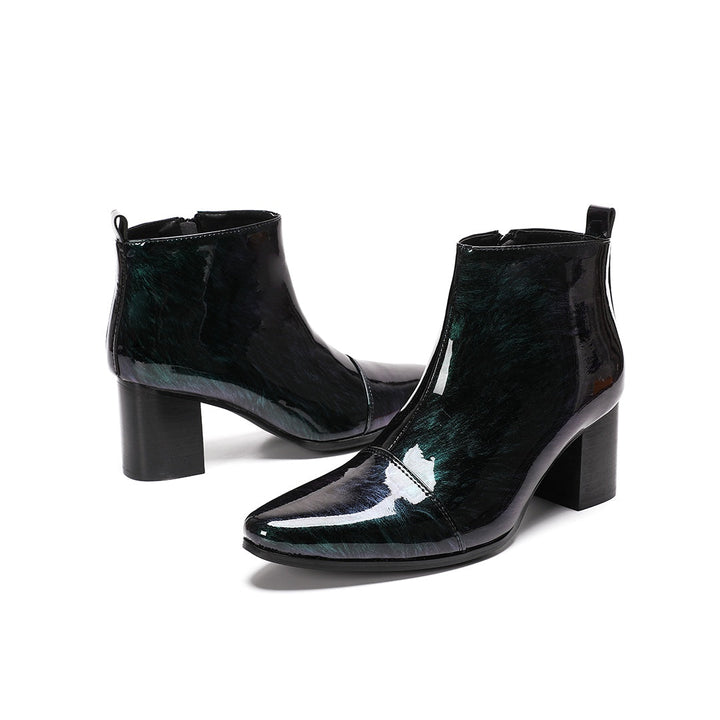 Pair of iridescent dark green patent leather pointed toe ankle boots with block heels and side zippers.
