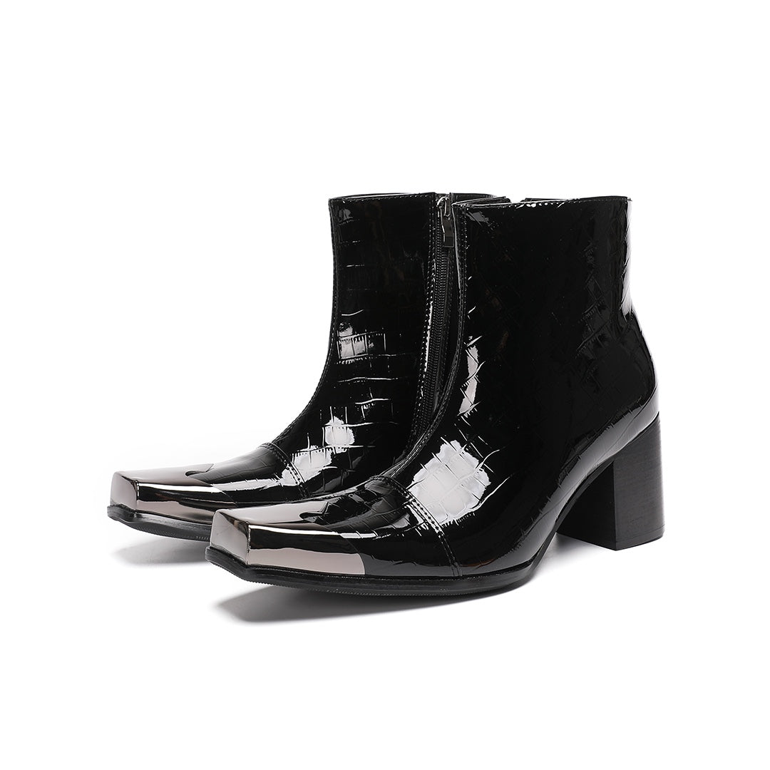 Pair of black patent crocodile embossed ankle boots with square metal toe caps and block heels, side view.