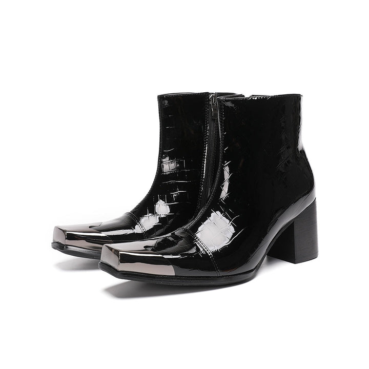 Pair of black patent crocodile embossed ankle boots with square metal toe caps and block heels, side view.