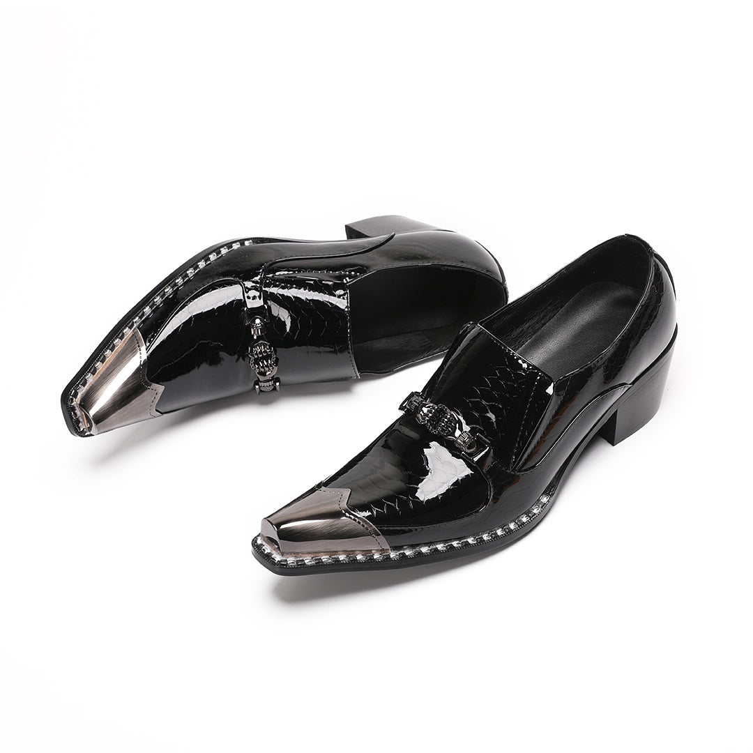 Pair of black patent leather men's loafers with silver metal cap toes and decorative buckles.