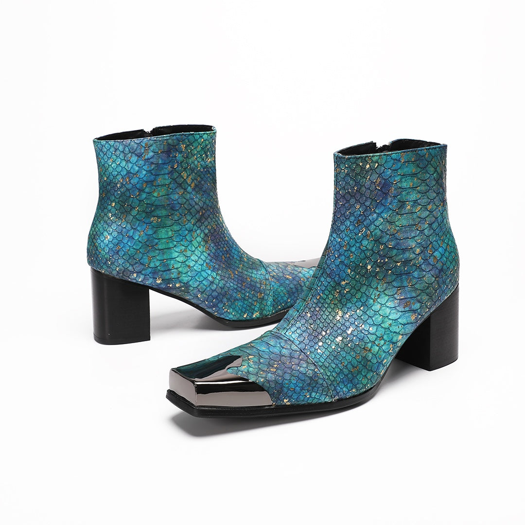 A pair of men's teal snake print ankle boots with a square metal tip and black block heel, shown on a white background.