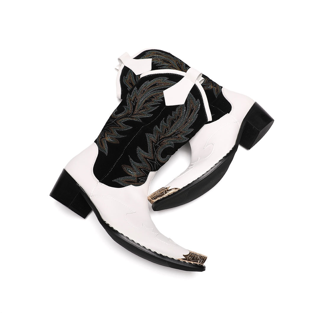 Pair of white and black embroidered cowboy boots with a gold metal tip on a white background.