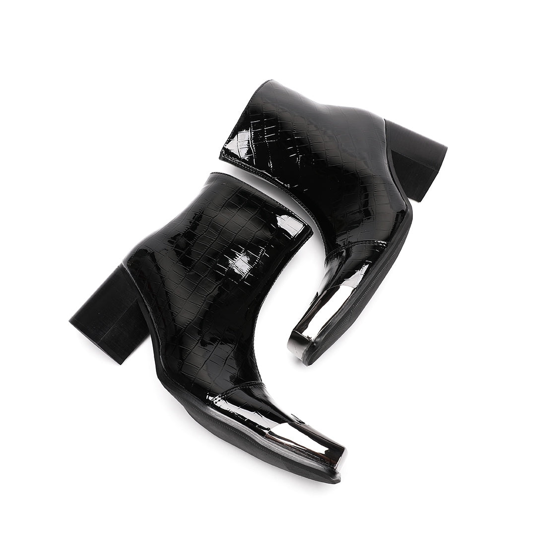 Pair of black patent crocodile embossed ankle boots with square metal toe caps and block heels, side view.