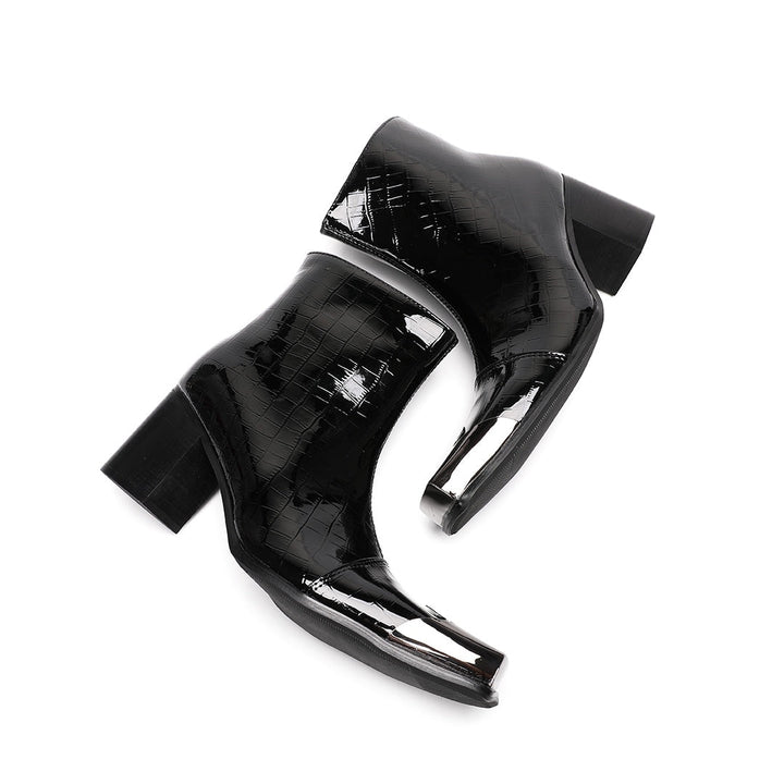 Pair of black patent crocodile embossed ankle boots with square metal toe caps and block heels, side view.