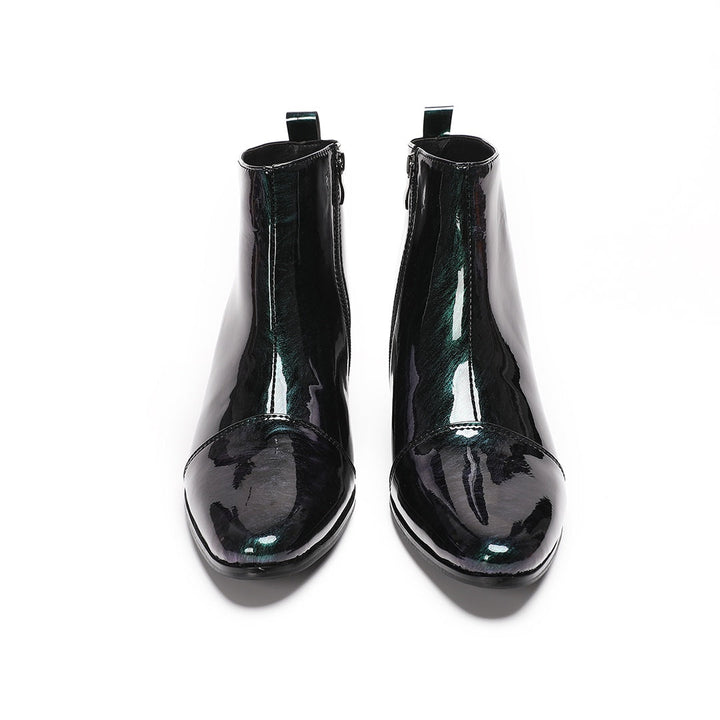 Pair of iridescent dark green patent leather pointed toe ankle boots with block heels and side zippers.