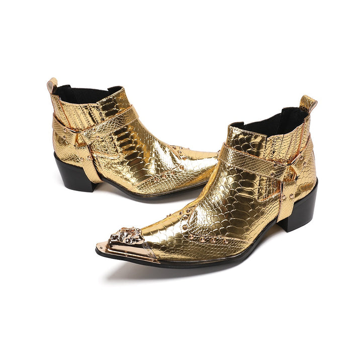 A pair of shiny gold snake skin textured ankle boots with a pointed metal toe cap, studded details, and an ankle strap.