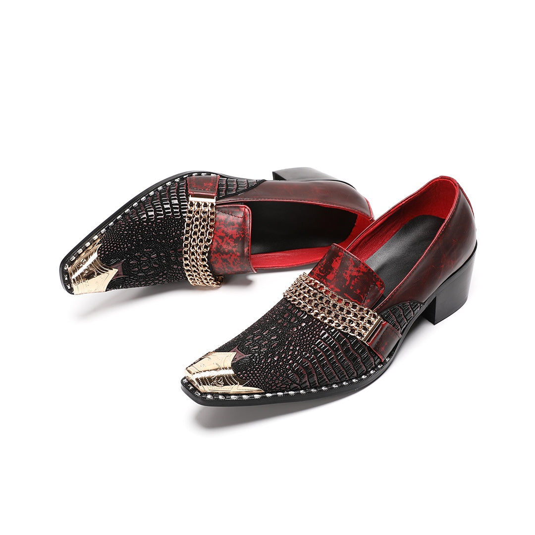 A pair of Dolashoes men's red and black textured leather loafers with gold metal toe caps and chain embellishments on a white