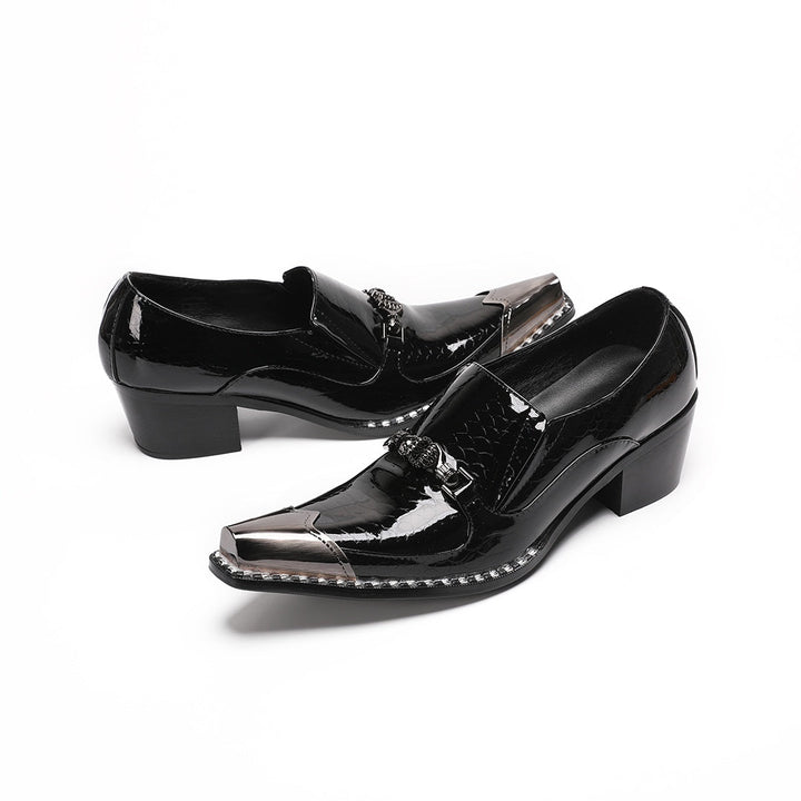 Pair of black patent leather men's loafers with silver metal cap toes and decorative buckles.