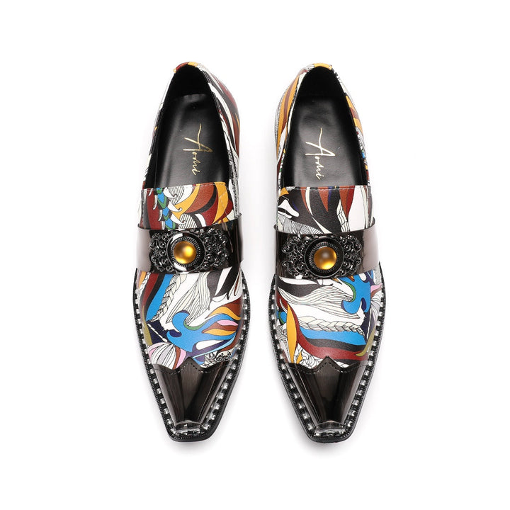 A single men's artistic patterned pointed toe shoe with a metal tip and an ornate buckle, displayed on a white background.