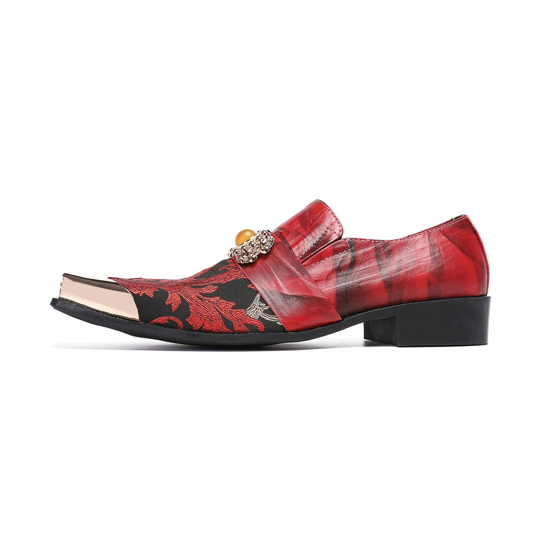 Pair of men's red and black floral slip-on loafers with gold metal square toe and decorative buckle.