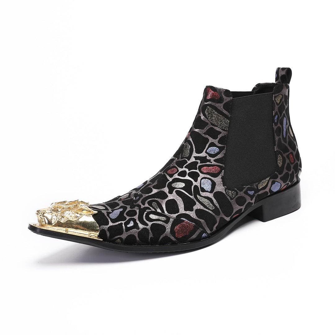Pair of men's black Chelsea boots with a metallic leopard print pattern and ornate gold metal toe caps, shown on a white