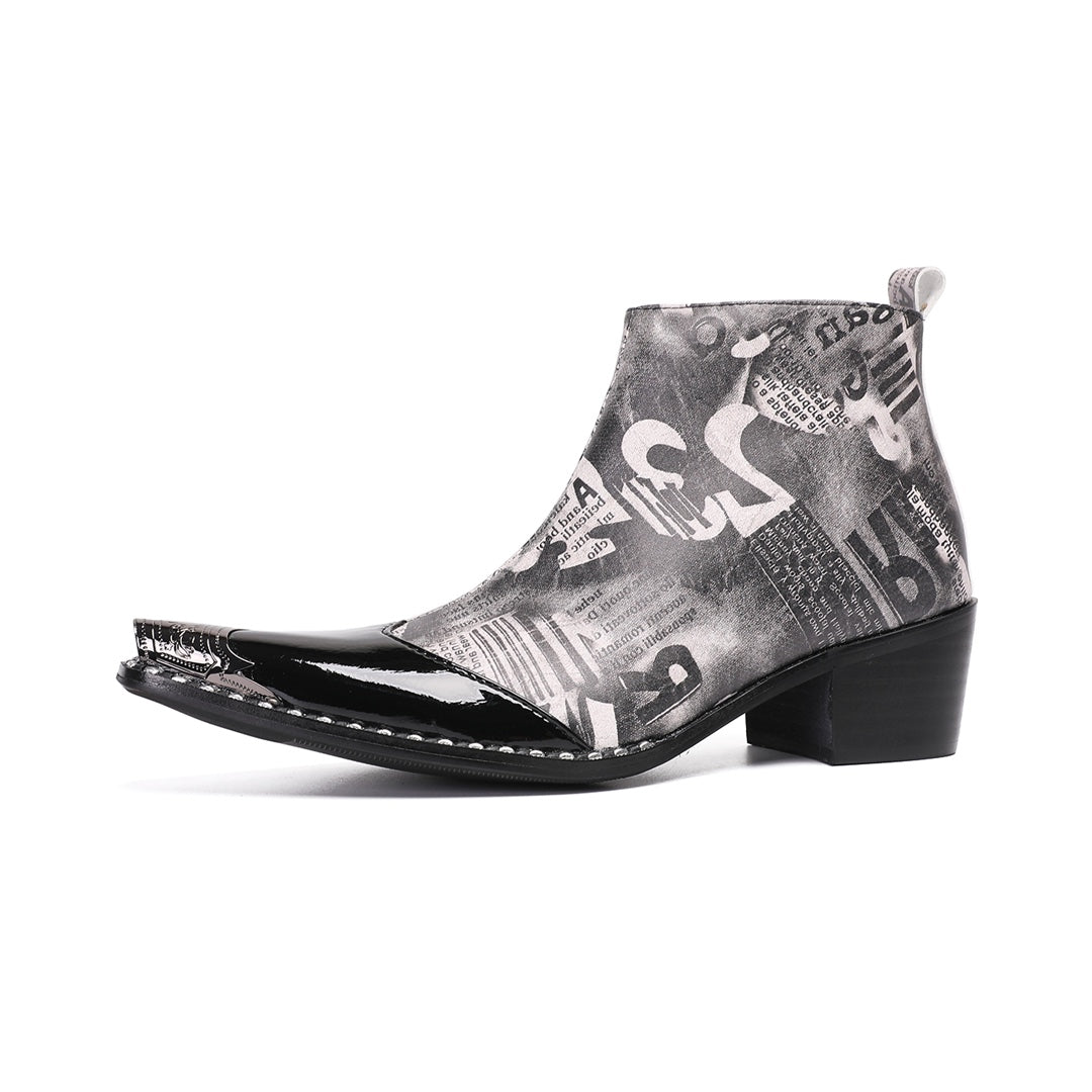 Pair of men's black and white newspaper print ankle boots with a shiny black pointed toe and silver metal tip, side zipper