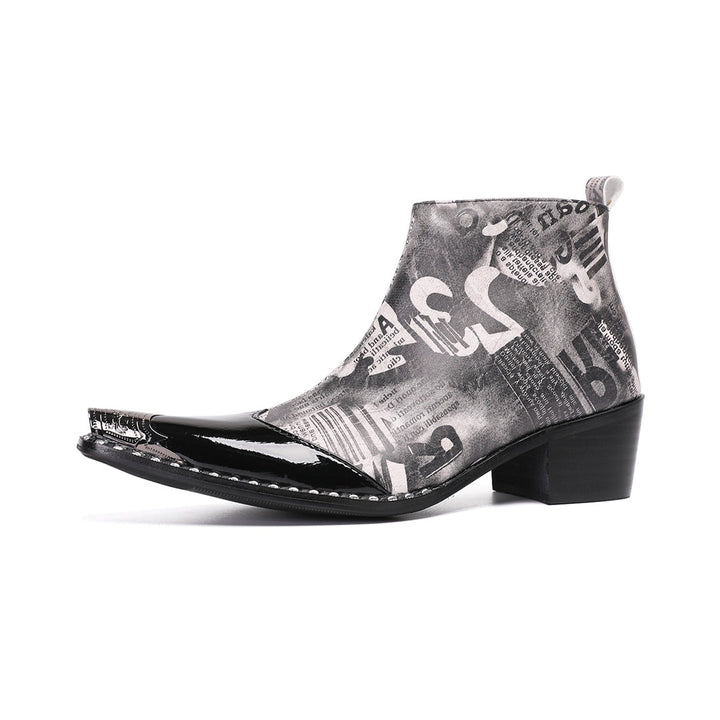 Pair of men's black and white newspaper print ankle boots with a shiny black pointed toe and silver metal tip, side zipper