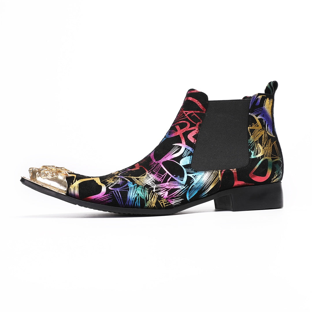 Pair of men's black Chelsea boots with a vibrant multi-color graffiti pattern and a gold metal pointed toe cap, shown from
