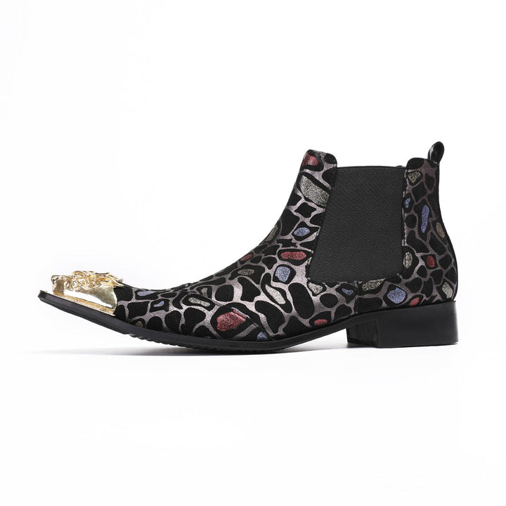 Pair of men's black Chelsea boots with a metallic leopard print pattern and ornate gold metal toe caps, shown on a white